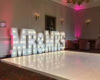The stunning Crathorne Hall Hotel with one of our gloss white Led Starlit dance floors and our giant Led Mr & Mrs with blush pink uplighting.