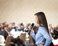 graphicstock-beautiful-business-woman-is-speaking-on-conference_BR74d1sbb
