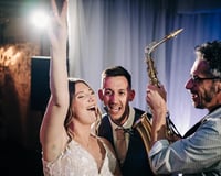 Saxophonist with bride and groom