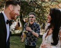 Saxophonist with bride and groom