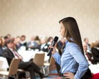 graphicstock-beautiful-business-woman-is-speaking-on-conference_BR74d1sbb