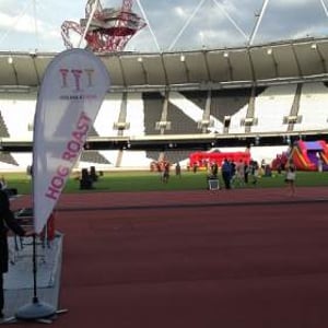 Anna holding the Hog Roast Sign at Olympic Stadium
