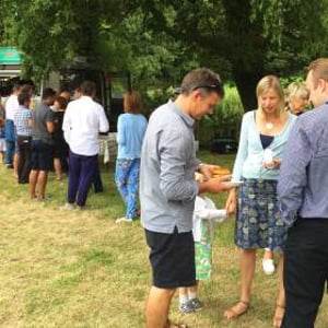 Queue for truck at farmhouse summer party