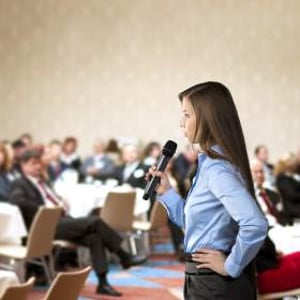 graphicstock-beautiful-business-woman-is-speaking-on-conference_BR74d1sbb