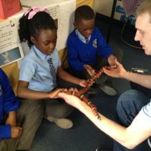 A very brave pupil holding Yazzoo the milk snake