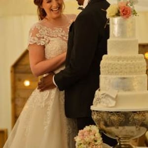 Bride and groom with their wedding cake 