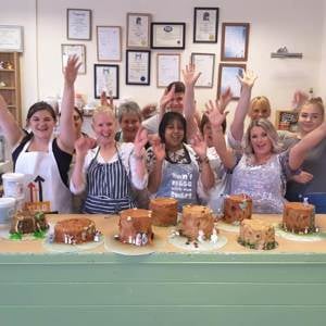 Group of pupils cheering after finishing their chocolate workshop.