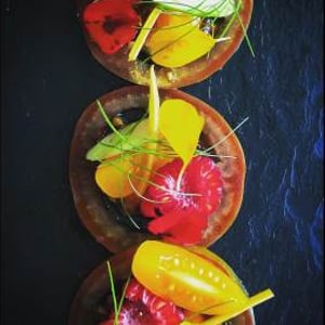Tomatoes and edible flowers from the kitchen garden. Canapé 