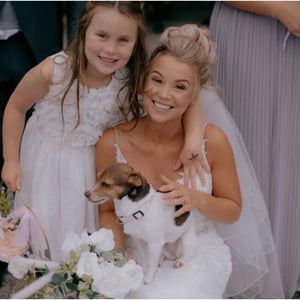 Bride posing with a surprise guest and her daughter