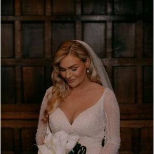Bride looking at boquet before ceremony