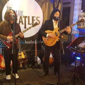 The Blue Beatles Duo performing in late era costumes