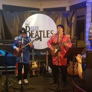 The Blue Beatles Duo performing in Sgt Pepper uniforms