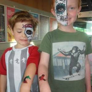Face paint + glitter tattoos = happy boys!