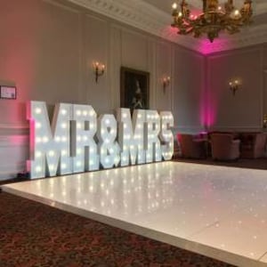 The stunning Crathorne Hall Hotel with one of our gloss white Led Starlit dance floors and our giant Led Mr & Mrs with blush pink uplighting.