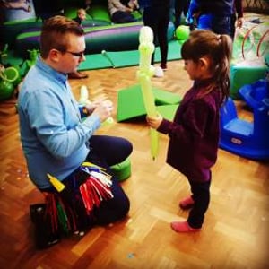 Making a dinosaur with a helper at a birthday party