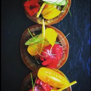Tomatoes and edible flowers from the kitchen garden. Canapé 