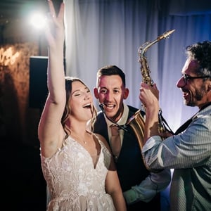 Saxophonist with bride and groom
