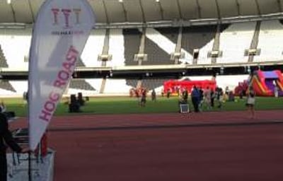 Anna holding the Hog Roast Sign at Olympic Stadium