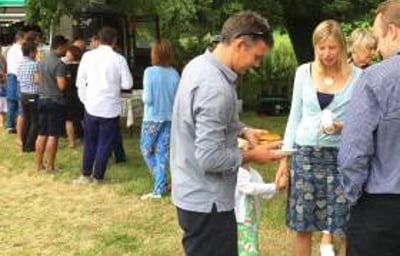 Queue for truck at farmhouse summer party
