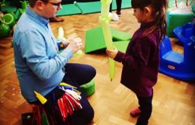 Making a dinosaur with a helper at a birthday party