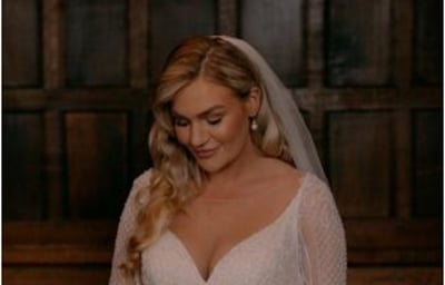 Bride looking at boquet before ceremony