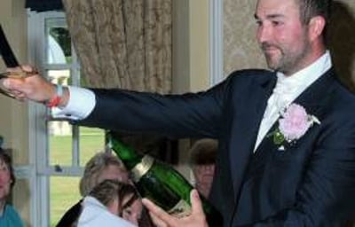 The Groom Takes Charge of the 'Sabrage'