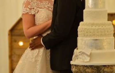 Bride and groom with their wedding cake 