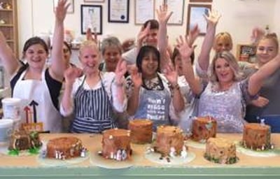 Group of pupils cheering after finishing their chocolate workshop.