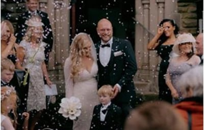 Bride and Groom walking through confetti after church wedding ceremony