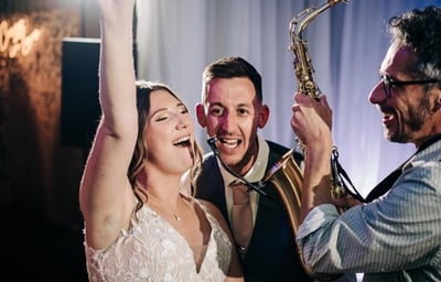 Saxophonist with bride and groom