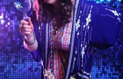 Fun Fortune Teller mingles through crowds with lighthearted insights, leaving guests laughing.