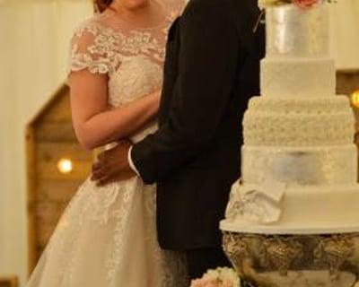 Bride and groom with their wedding cake