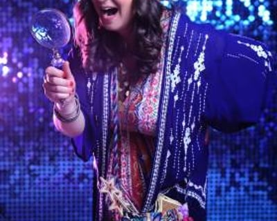 Fun Fortune Teller mingles through crowds with lighthearted insights, leaving guests laughing.